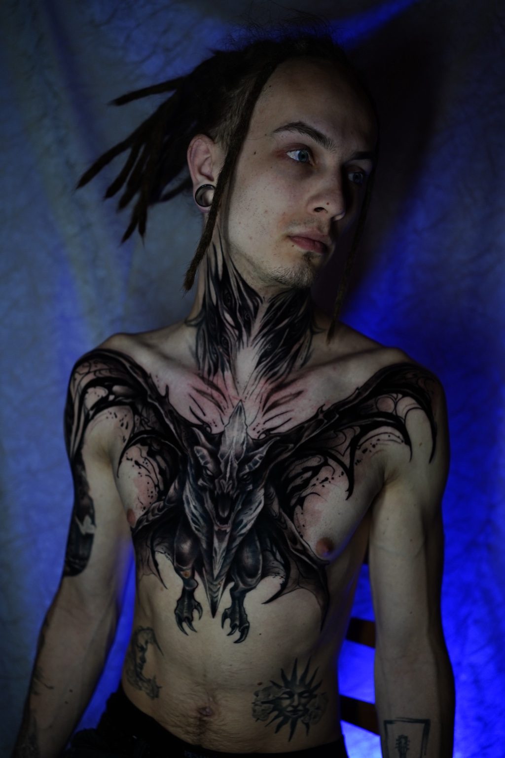 Black and grey dragon chest tattoo by Henry D. Flores