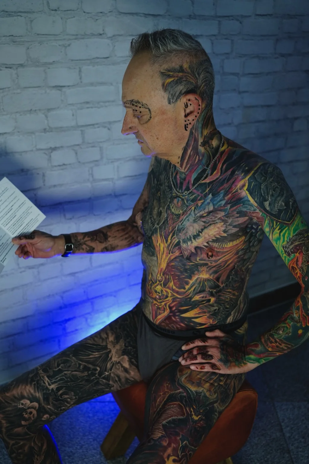 Editorial portrait showing a full-body fantasy tattoo project by Henry D. Flores
