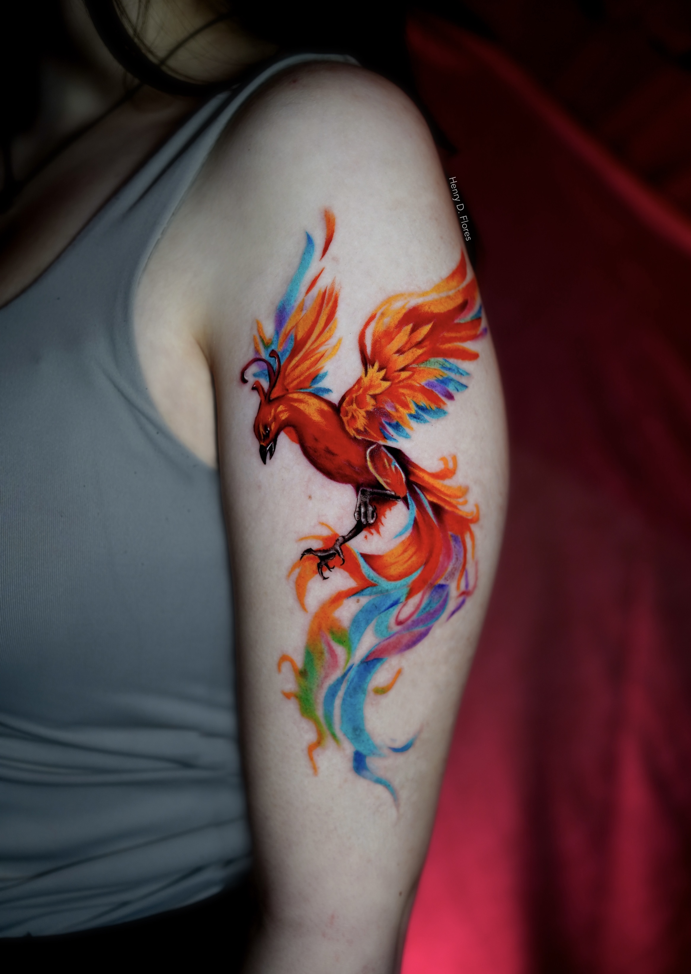 Phoenix watercolor upper arm tattoo by Henry D. Flores
