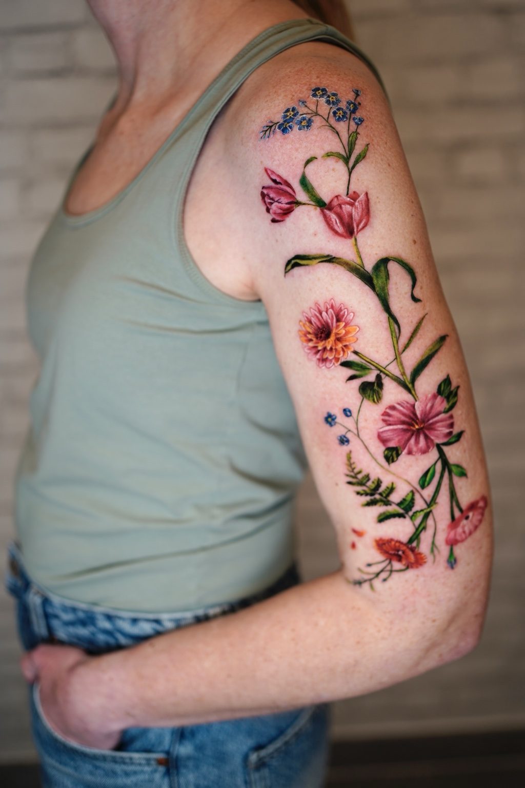 Wildflowers and butterflies color arm tattoo by Henry D. Flores